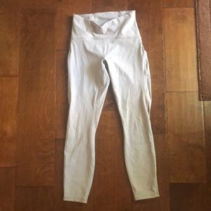 Taupe grey Lululemon capri leggings with mesh accents on the side of the legs